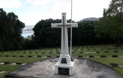 A white RSA cross at a cemetery. 
